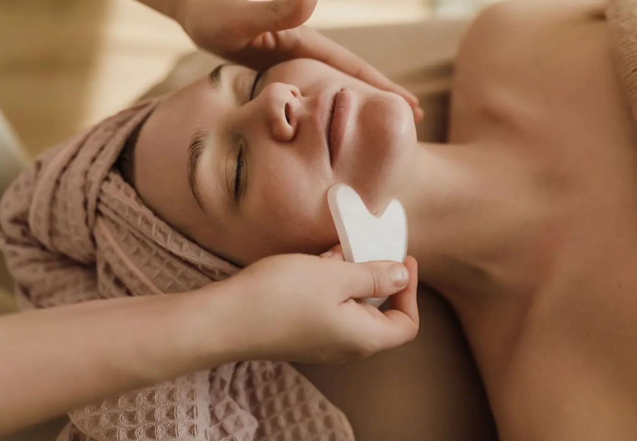 Woman at a medical spa having her face treated with body contouring