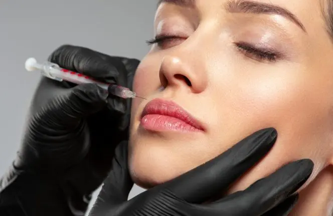 Woman receiving botox injections around her mouth