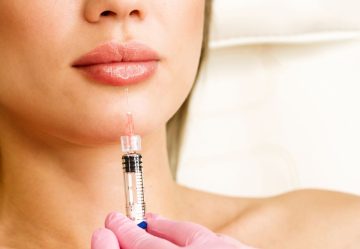 8 Things to Know About Lip Fillers Closeup of syringe next to woman's lips about to inject lip fillers